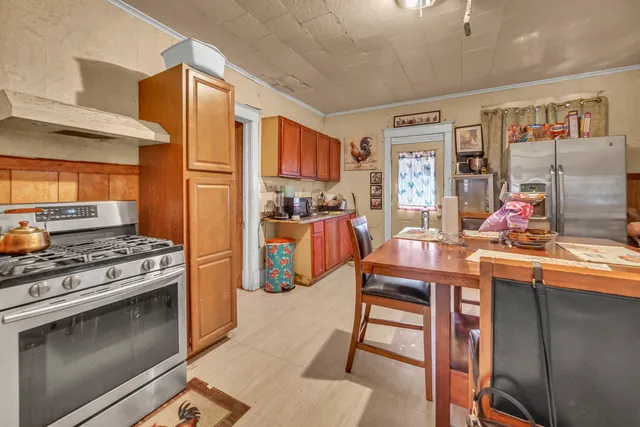 a kitchen with stainless steel appliances granite countertop a stove and a refrigerator