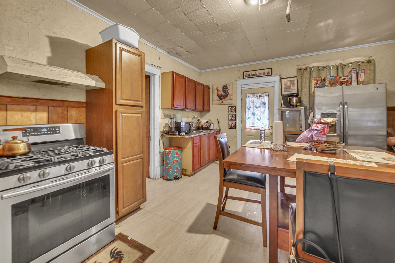 720 Meeker Avenue Joliet, IL 60432 - Photo 11 of 20 a kitchen with stainless steel appliances granite countertop a stove and a refrigerator