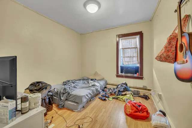 a bedroom with a bed and a window