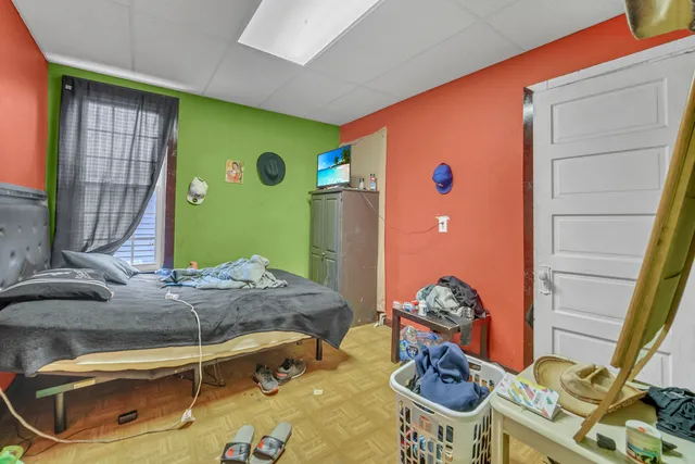 a bedroom with a bed and a mirror