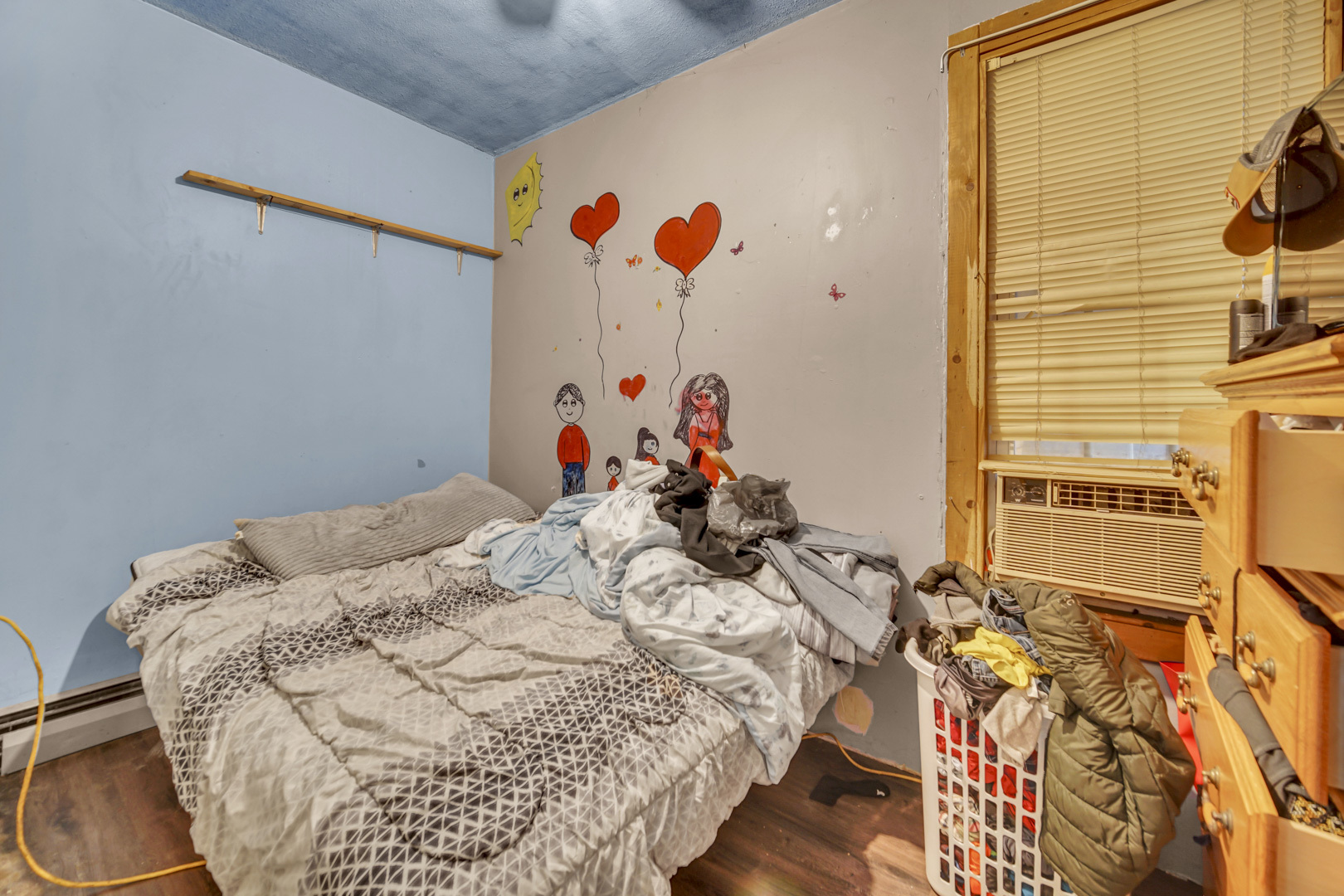 720 Meeker Avenue Joliet, IL 60432 - Photo 16 of 20 a bed room with a bed and a painting on the wall