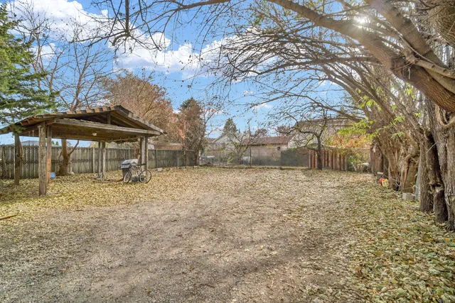 a backyard of a house with table and chairs