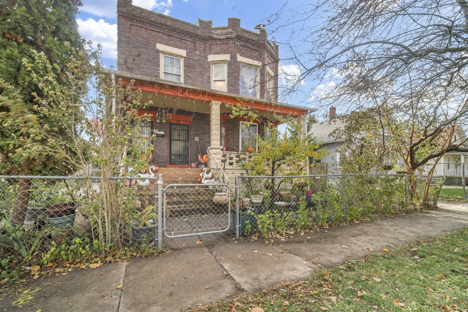 720 Meeker Avenue Joliet, IL 60432 - Photo 2 of 20 front view of a brick house with a large tree