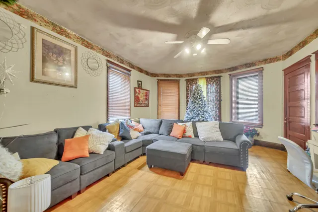 a living room with furniture and large windows