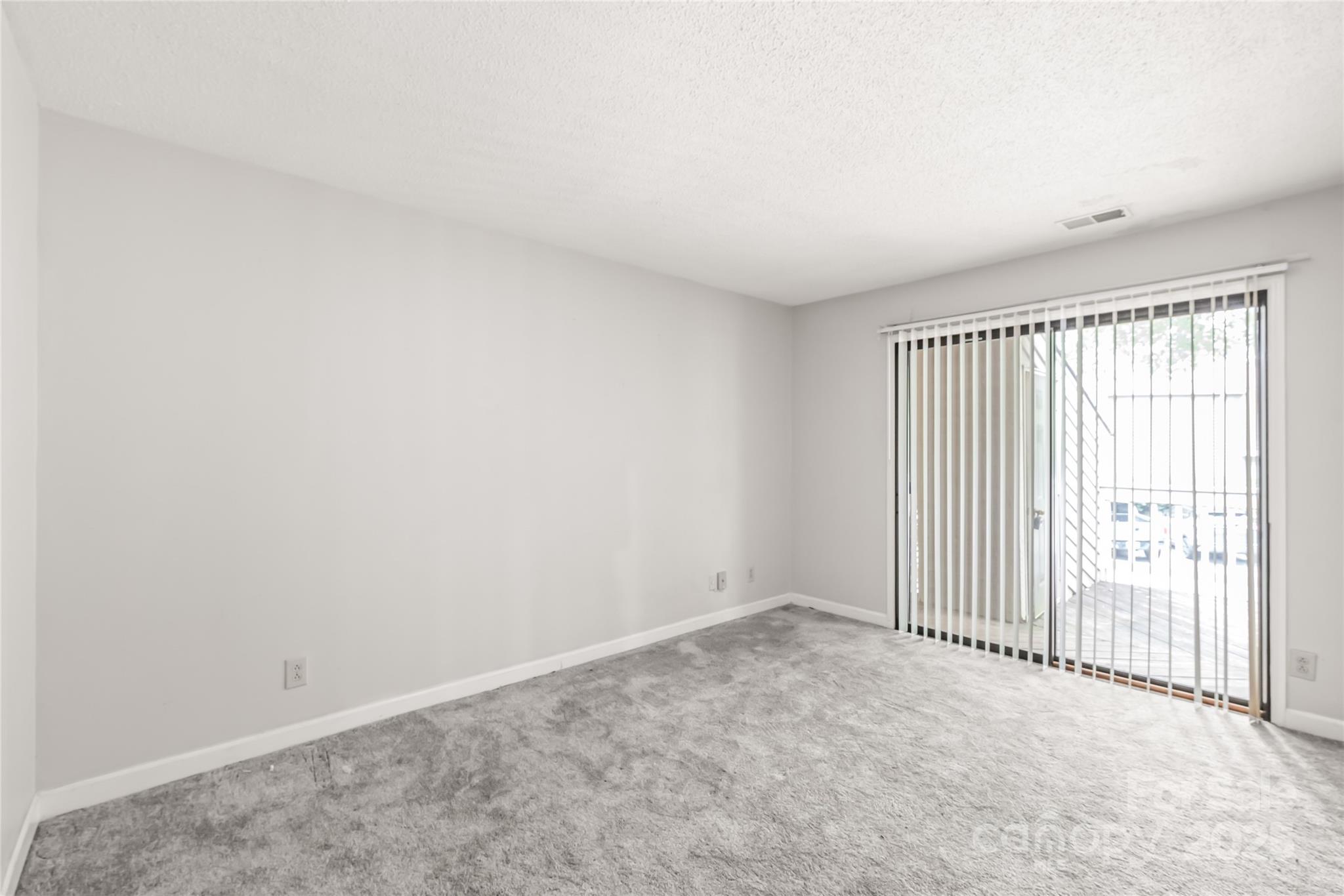 1612 Sharon Road West, Unit 70 Charlotte, NC 28210 - Photo 12 of 18 an empty room with windows