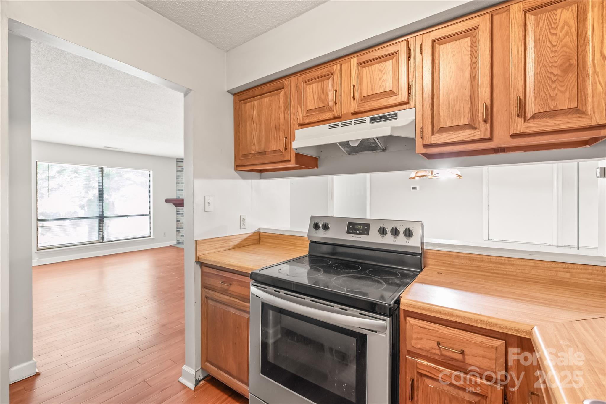 1612 Sharon Road West, Unit 70 Charlotte, NC 28210 - Photo 13 of 18 a kitchen with stainless steel appliances granite countertop a stove a sink and a microwave