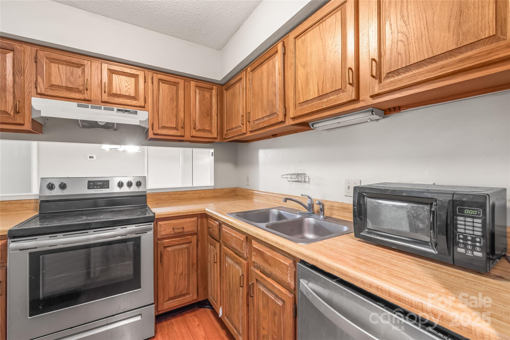 1612 Sharon Road West, Unit 70 Charlotte, NC 28210 - Photo 15 of 18 a kitchen with granite countertop a stove microwave and sink
