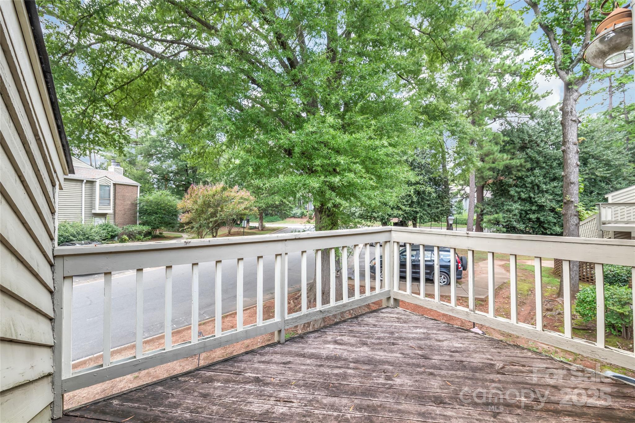 1612 Sharon Road West, Unit 70 Charlotte, NC 28210 - Photo 17 of 18 a balcony with wooden floor and fence