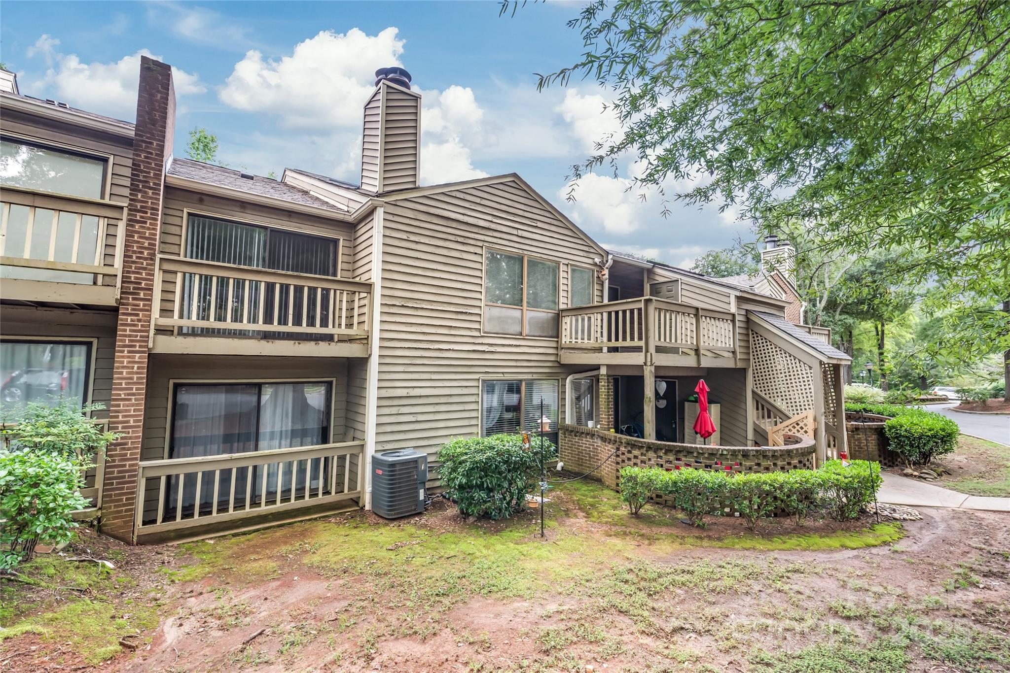 1612 Sharon Road West, Unit 70 Charlotte, NC 28210 - Photo 2 of 18 a front view of a house with garden