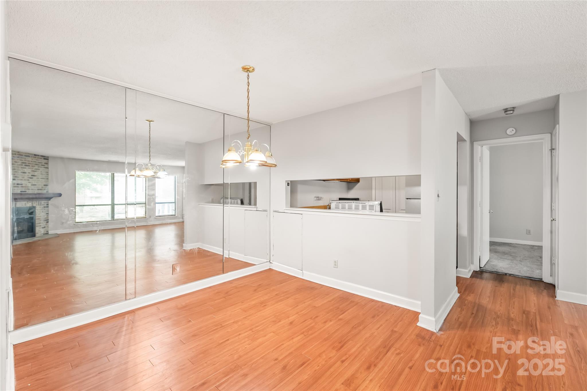 1612 Sharon Road West, Unit 70 Charlotte, NC 28210 - Photo 8 of 18 a view of a room with wooden floor and kitchen view
