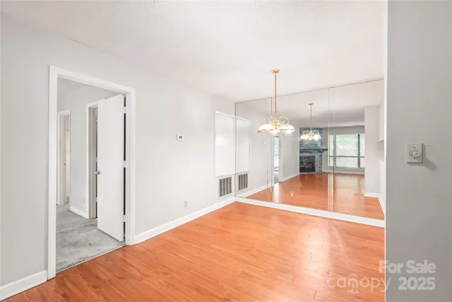 a room with natural light and hardwood floor