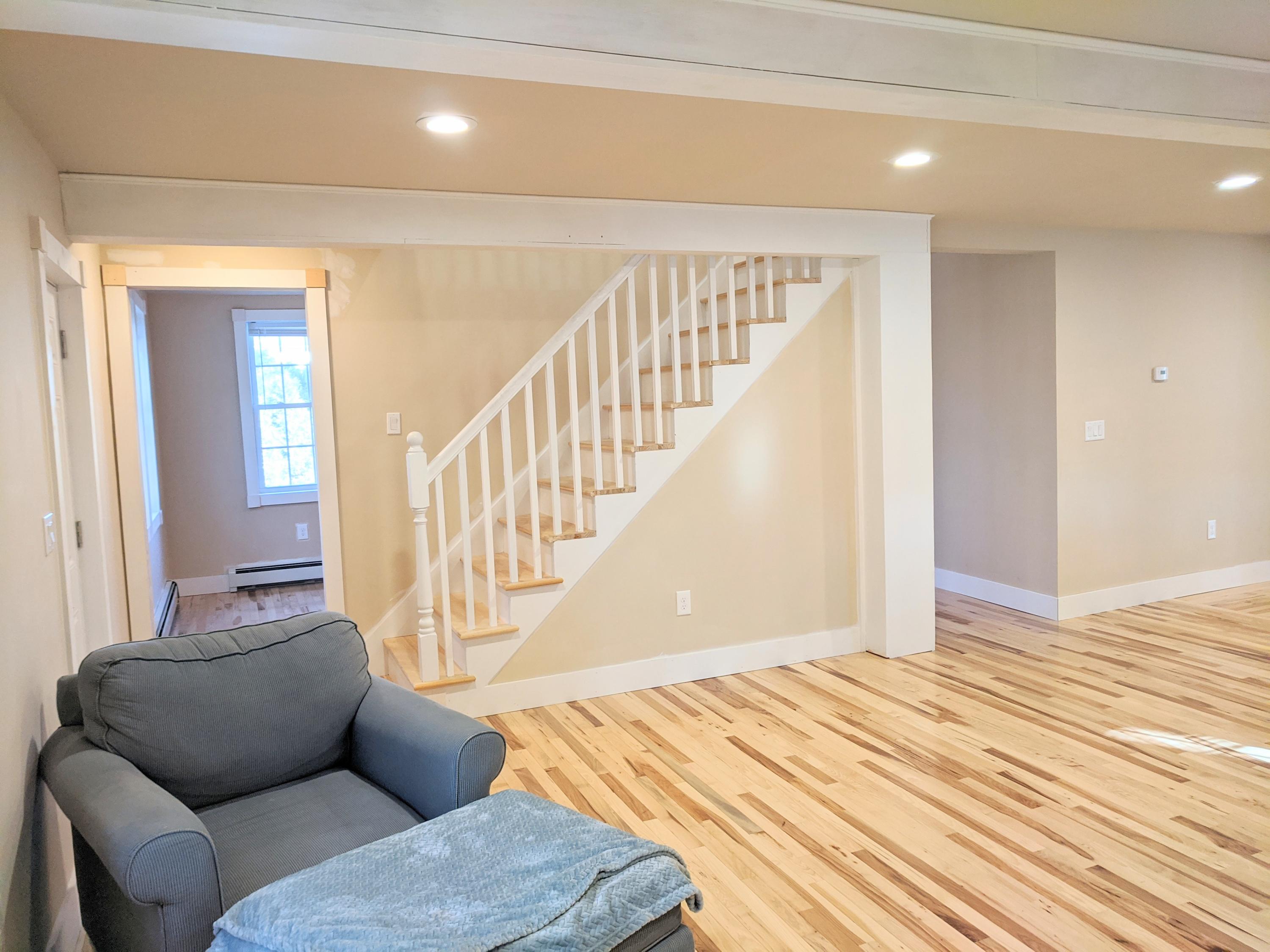 119 Tupper Road Sandwich, MA 02563 - Photo 4 of 32 a living room with furniture and stairs
