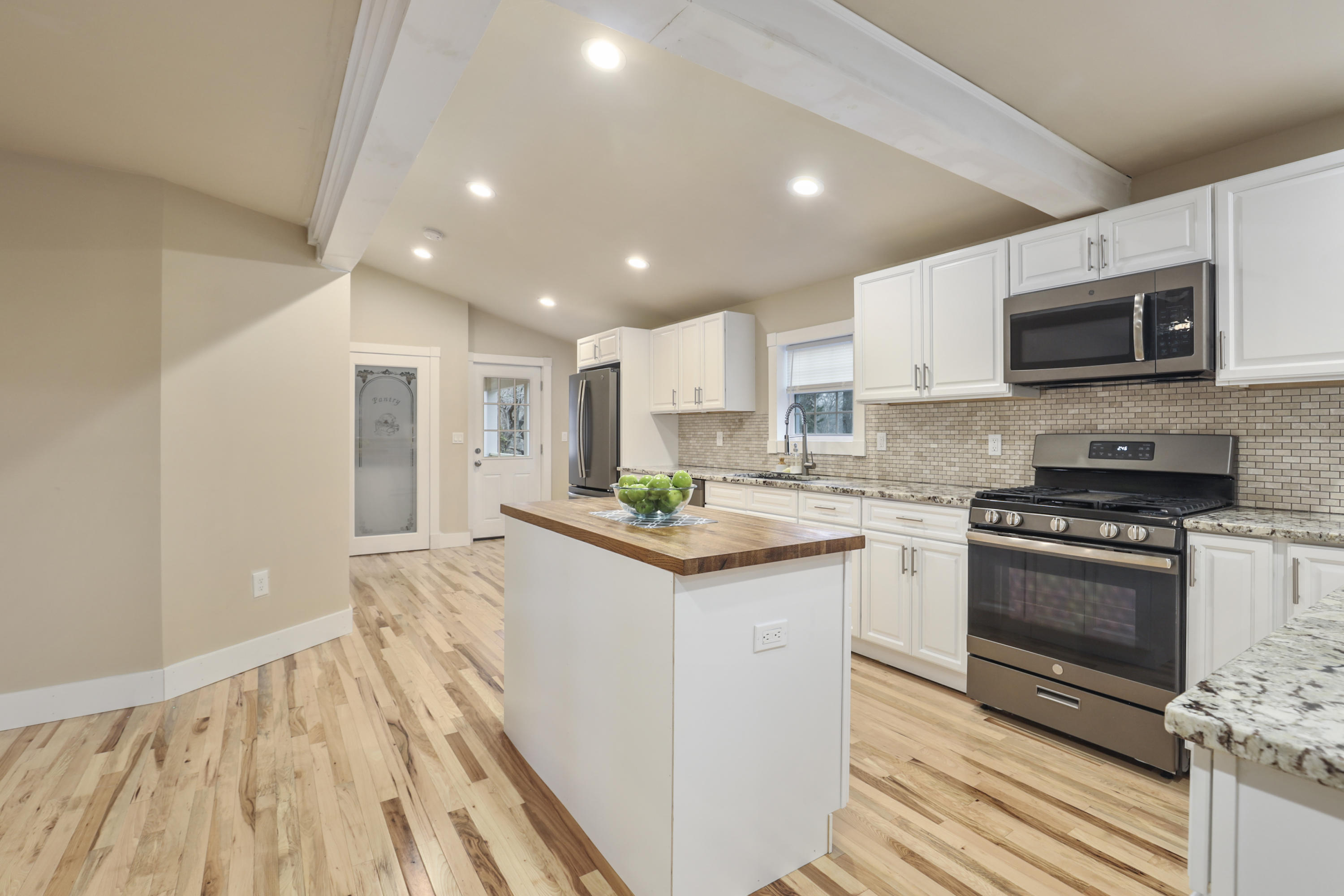 119 Tupper Road Sandwich, MA 02563 - Photo 8 of 32 a kitchen with stainless steel appliances granite countertop a stove top oven a sink and a microwave