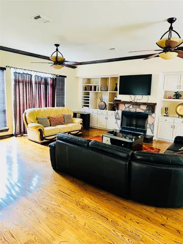 a living room with fireplace furniture and a flat screen tv