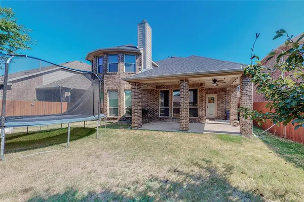 a view of a house with a yard and sitting area