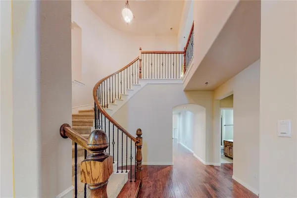 a view of entryway and hall with wooden floor