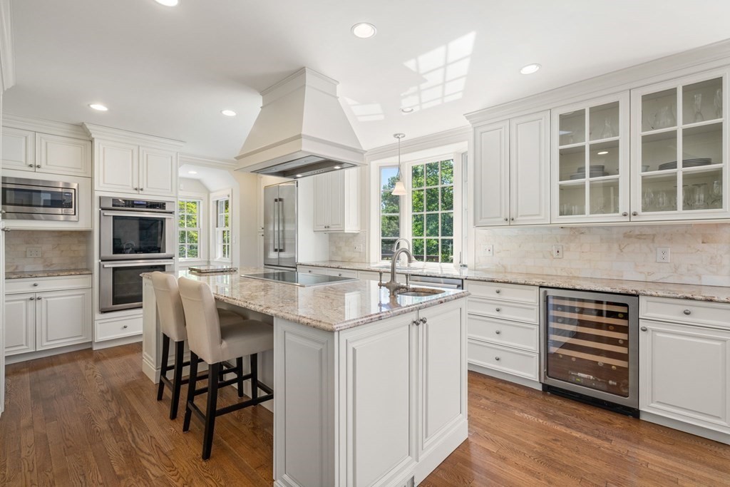 63 Bonad Road Newton, MA 02465 - Photo 3 of 15 a kitchen with kitchen island granite countertop a sink cabinets and wooden floor