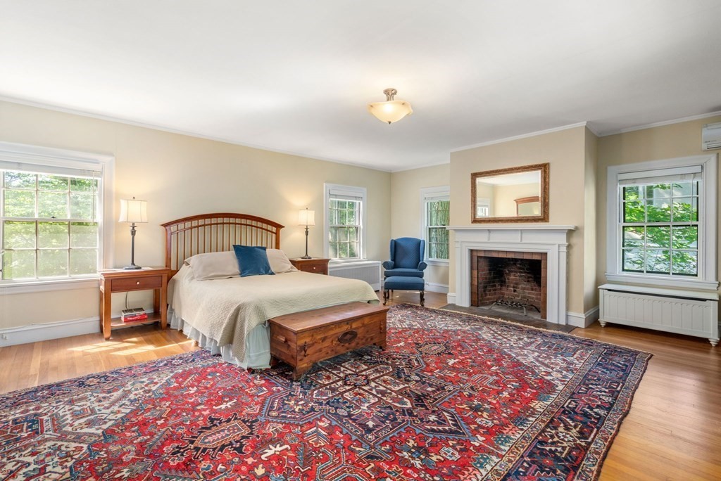 63 Bonad Road Newton, MA 02465 - Photo 9 of 15 a spacious bedroom with a bed and a fireplace