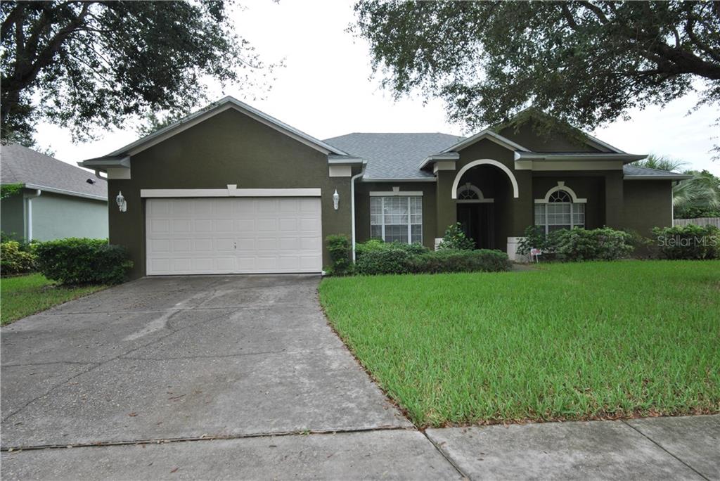 1918 Rachels Ridge Loop Ocoee, FL 34761 - Photo 1 of 1 a front view of a house with garden