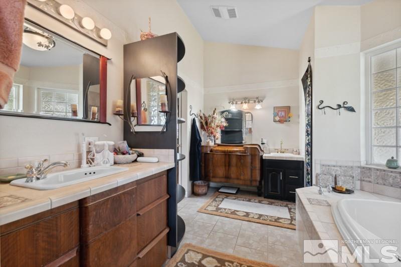 21025 Ames Lane Reno, NV 89521 - Photo 20 of 34 a spacious bathroom with a sink double vanity and a mirror
