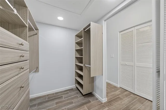 a view of walk in closet with empty racks