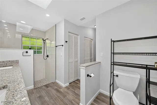 a bathroom with a shower toilet and sink