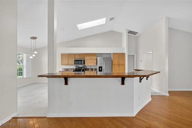 a kitchen with stainless steel appliances granite countertop a sink and cabinets