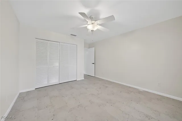 an empty room with a ceiling fan and a ceiling fan