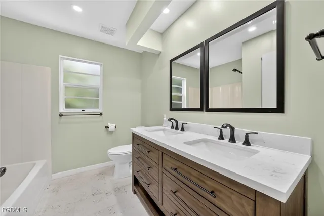 a bathroom with a sink double vanity and a mirror