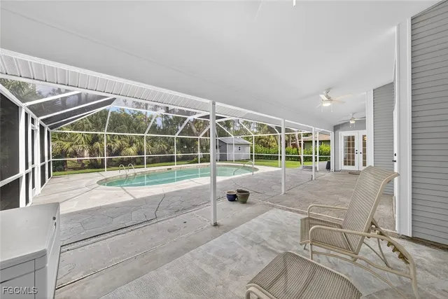 a view of house with a big yard and large windows