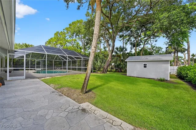 a view of a house with a backyard and a tree