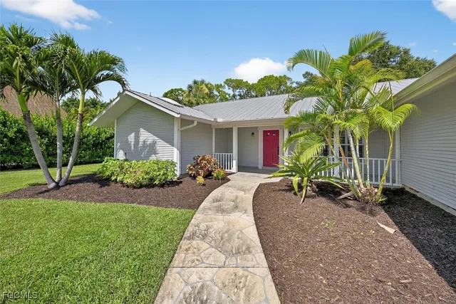 a potted plant sitting in front of a house