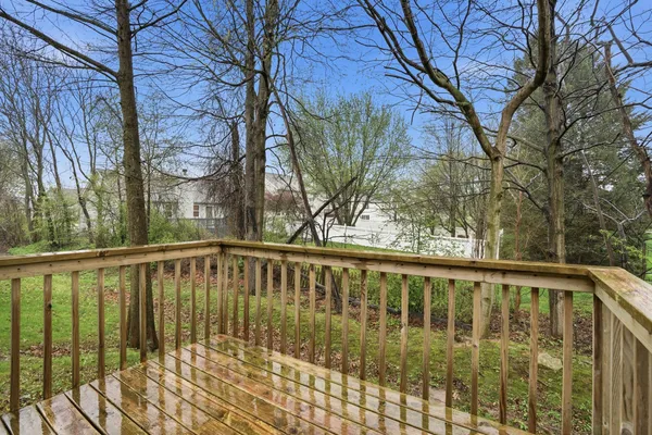 a view of balcony with wooden floor and fence