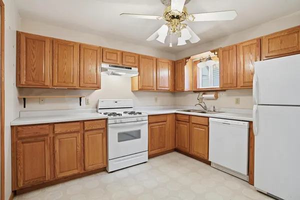 a kitchen with granite countertop cabinets stainless steel appliances and a window