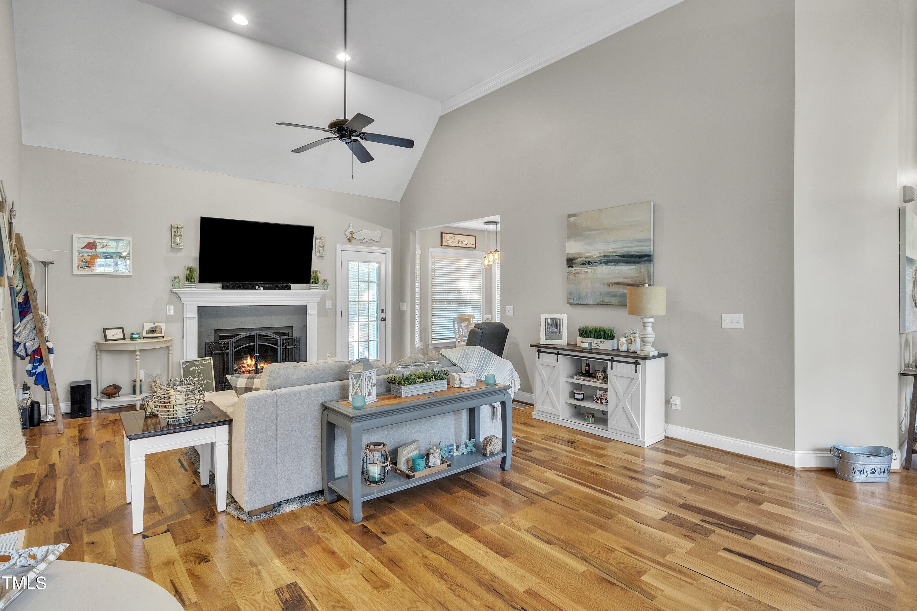 4617 Cherrybark Lane Raleigh, NC 27616 - Photo 17 of 53 a living room with furniture a fireplace and a flat screen tv