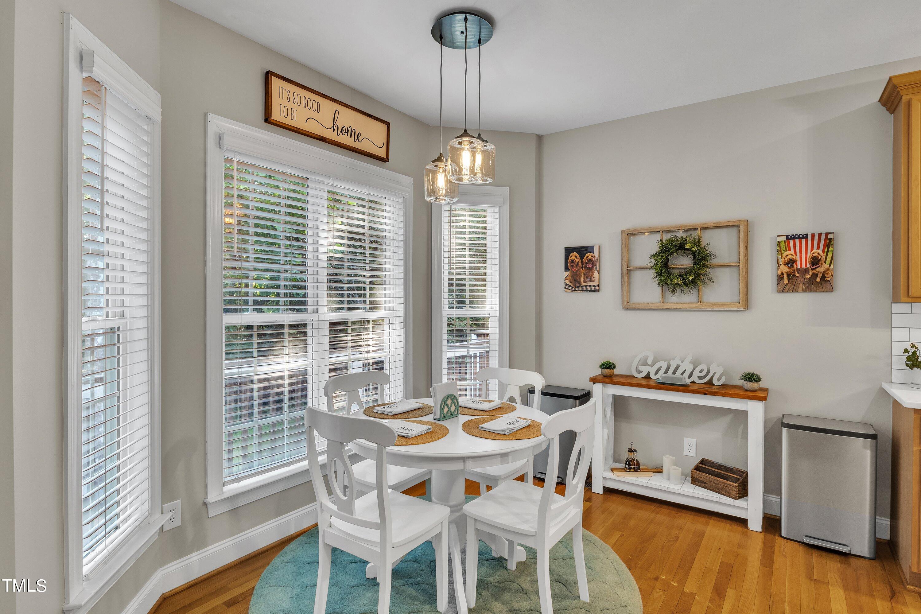 4617 Cherrybark Lane Raleigh, NC 27616 - Photo 21 of 53 a dining room with furniture a chandelier and wooden floor