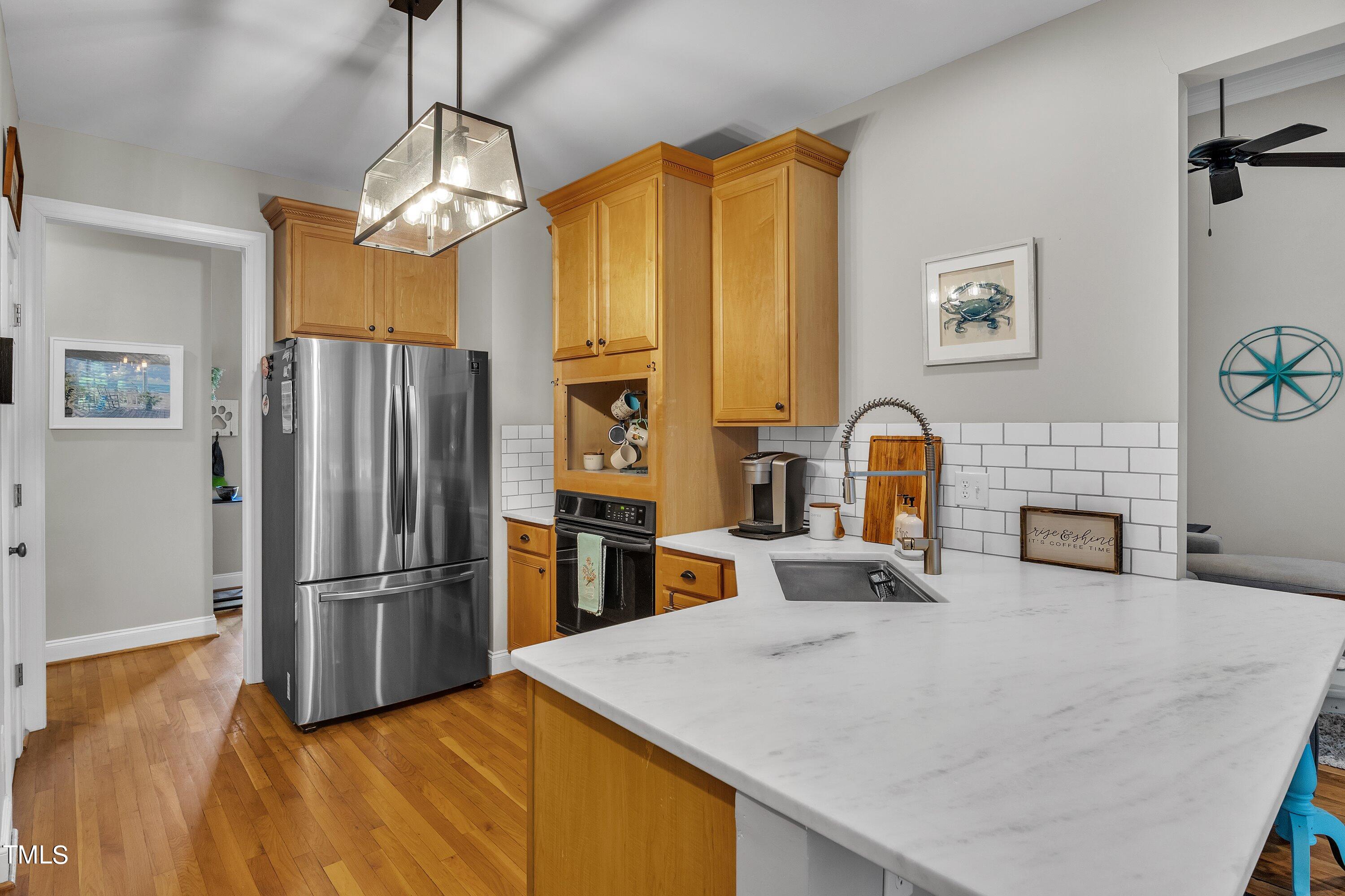 4617 Cherrybark Lane Raleigh, NC 27616 - Photo 25 of 53 a kitchen with stainless steel appliances a refrigerator sink and stove