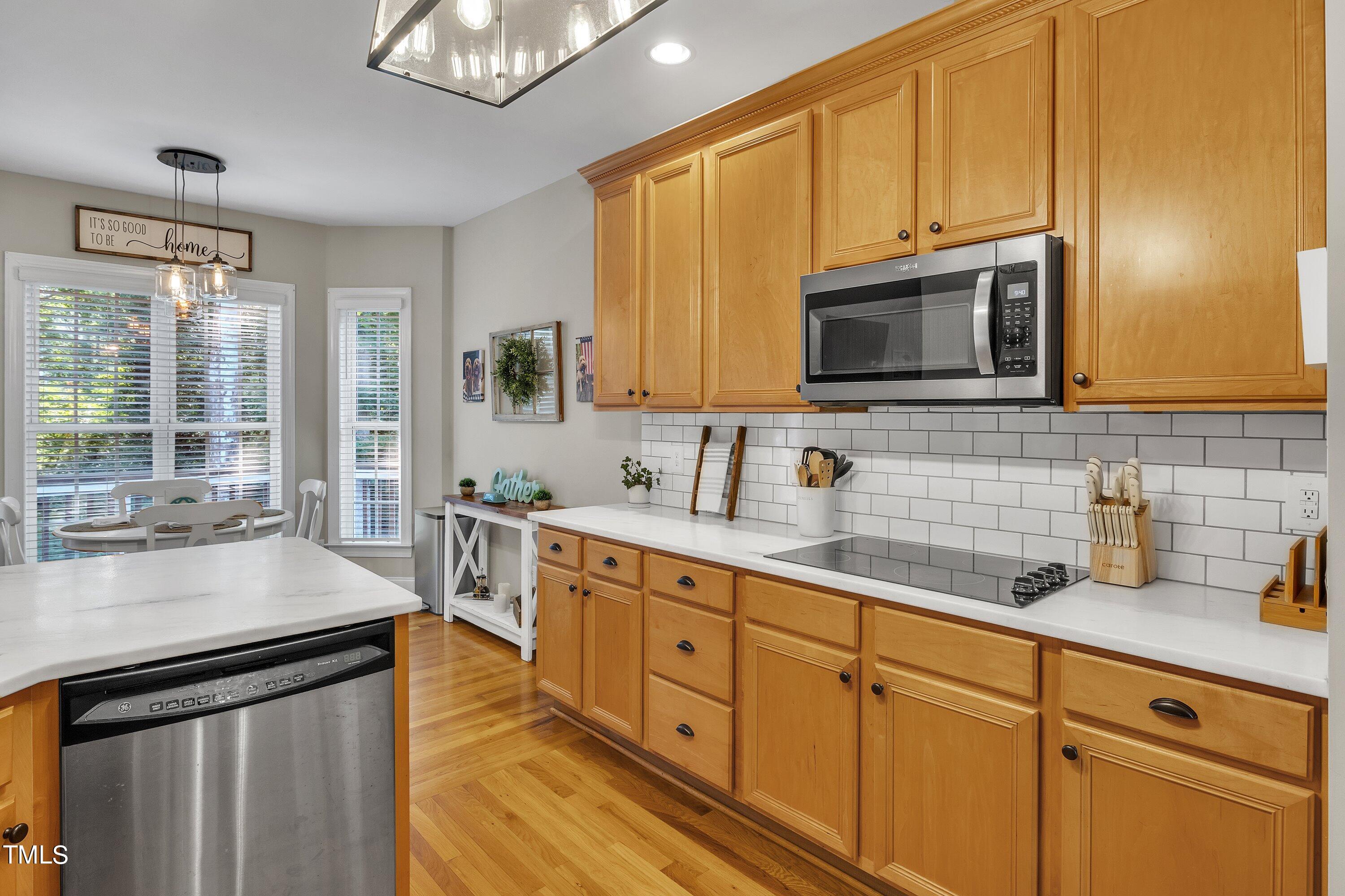 4617 Cherrybark Lane Raleigh, NC 27616 - Photo 26 of 53 a kitchen with stainless steel appliances granite countertop a sink stove and microwave