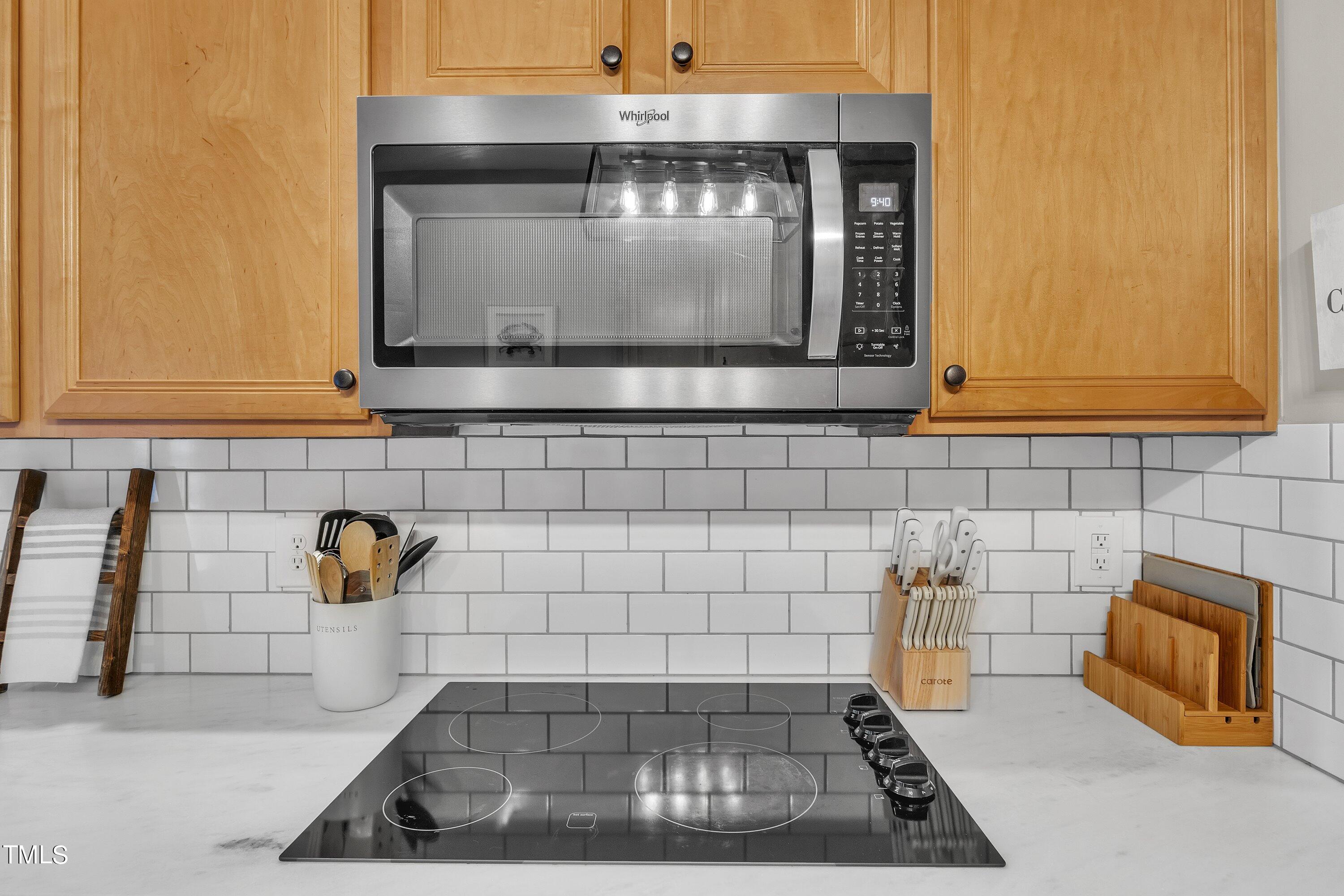 4617 Cherrybark Lane Raleigh, NC 27616 - Photo 27 of 53 a kitchen with granite countertop a stove a sink and a microwave
