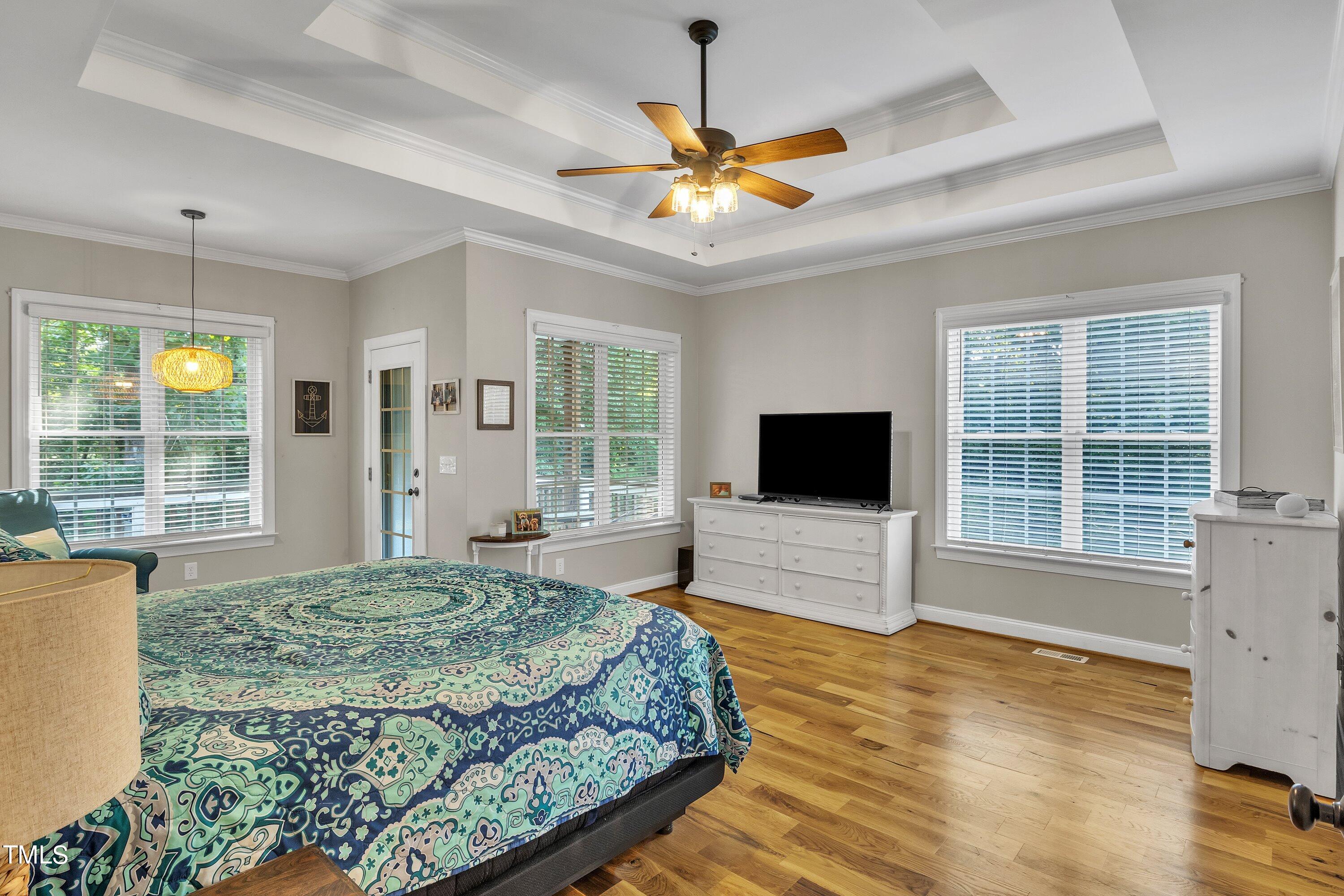 4617 Cherrybark Lane Raleigh, NC 27616 - Photo 32 of 53 a living room with a bed furniture and a flat screen tv