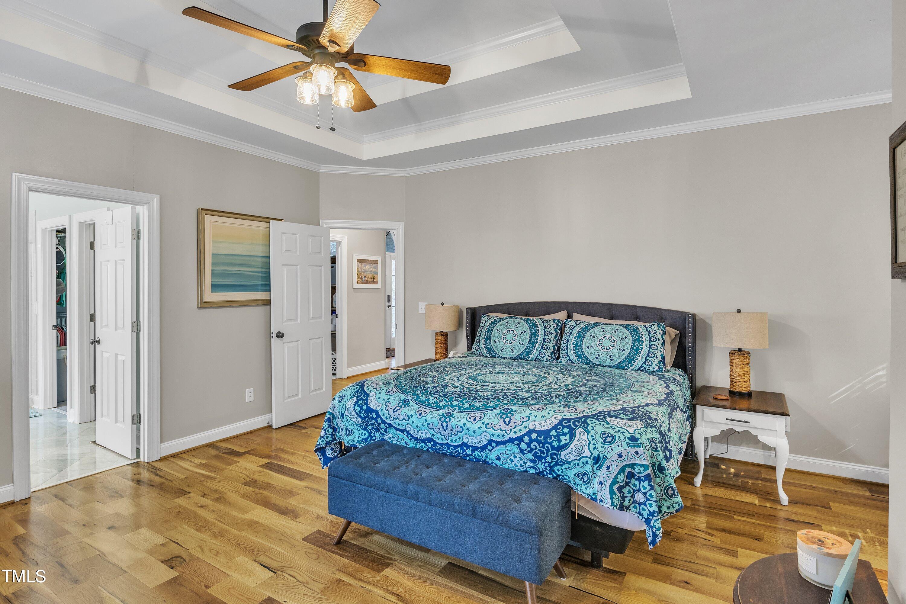 4617 Cherrybark Lane Raleigh, NC 27616 - Photo 34 of 53 a bedroom with a bed and a chandelier