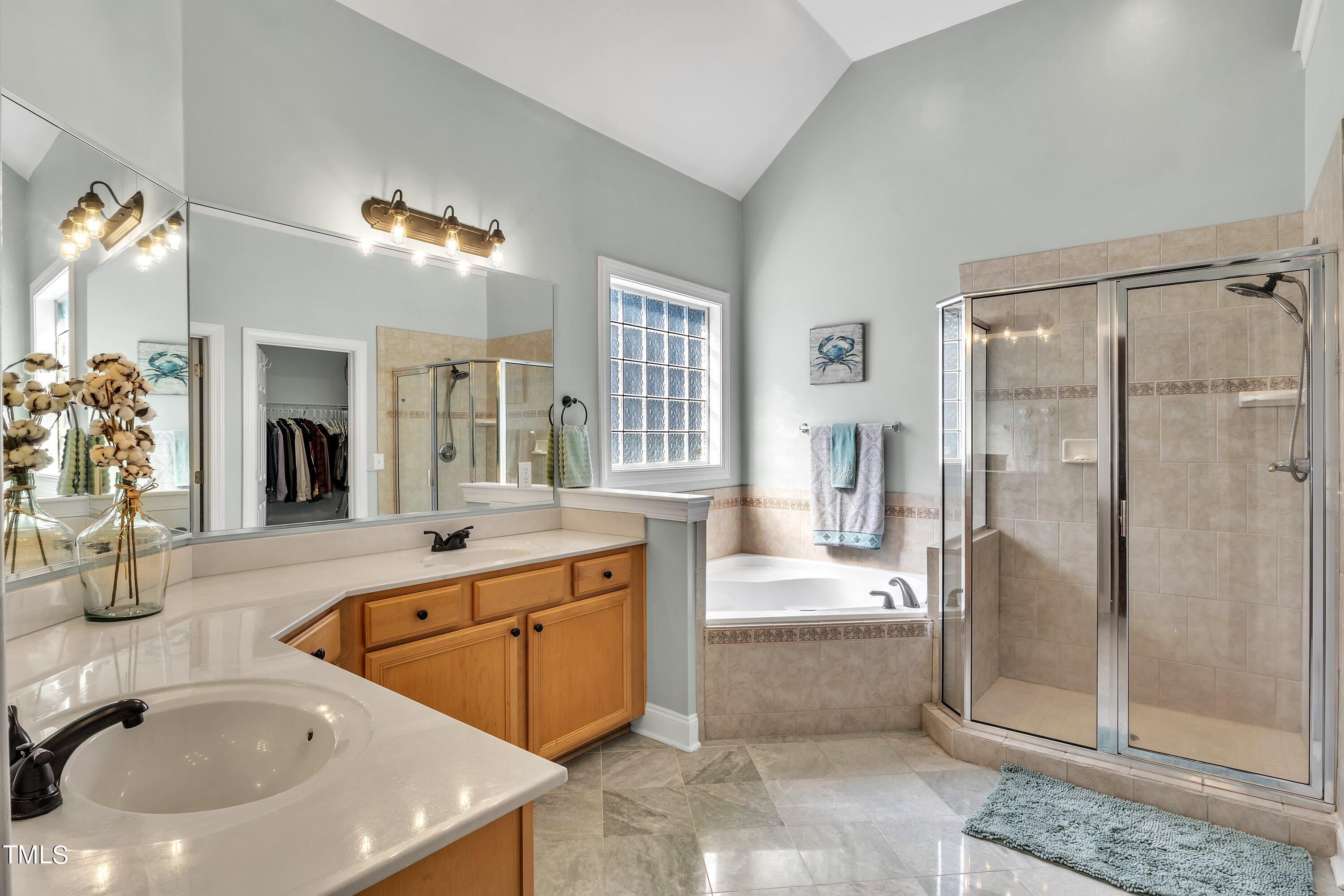 4617 Cherrybark Lane Raleigh, NC 27616 - Photo 37 of 53 a spacious bathroom with a tub sink and mirror