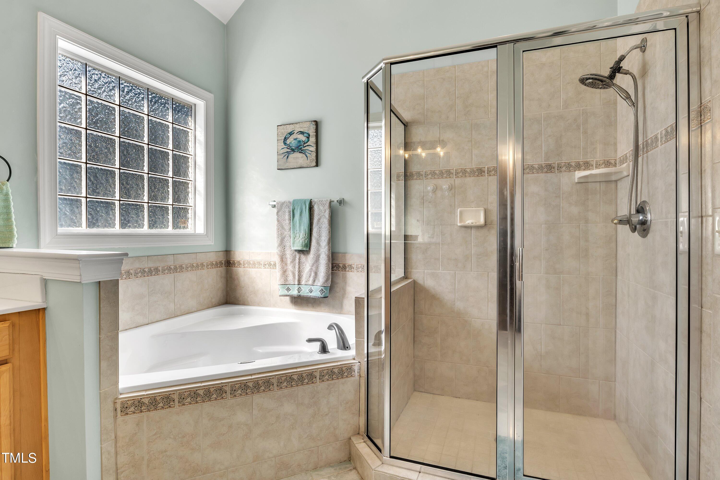 4617 Cherrybark Lane Raleigh, NC 27616 - Photo 38 of 53 a bathroom with a bathtub and a shower