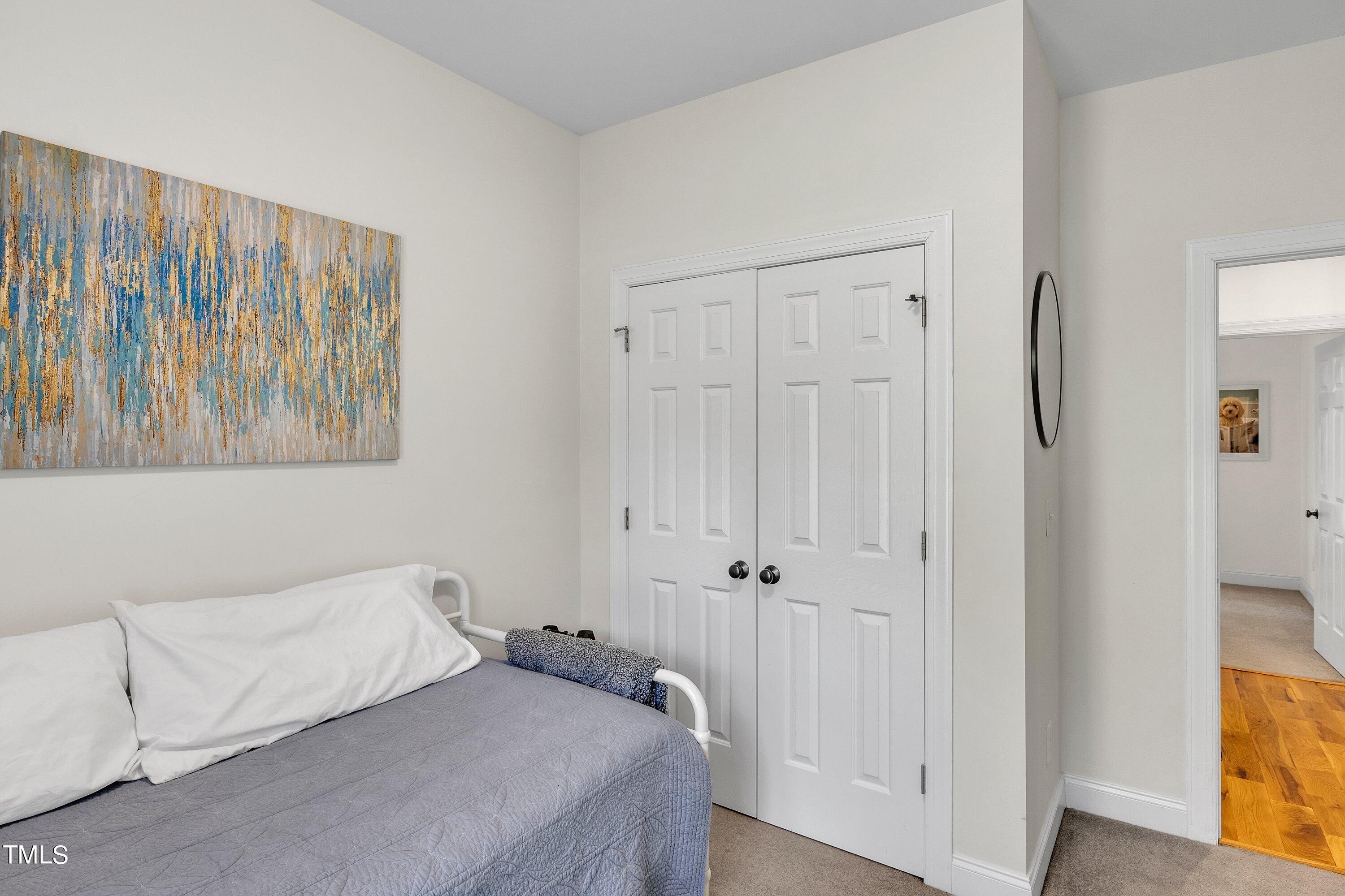 4617 Cherrybark Lane Raleigh, NC 27616 - Photo 42 of 53 a bedroom with a bed and a tv