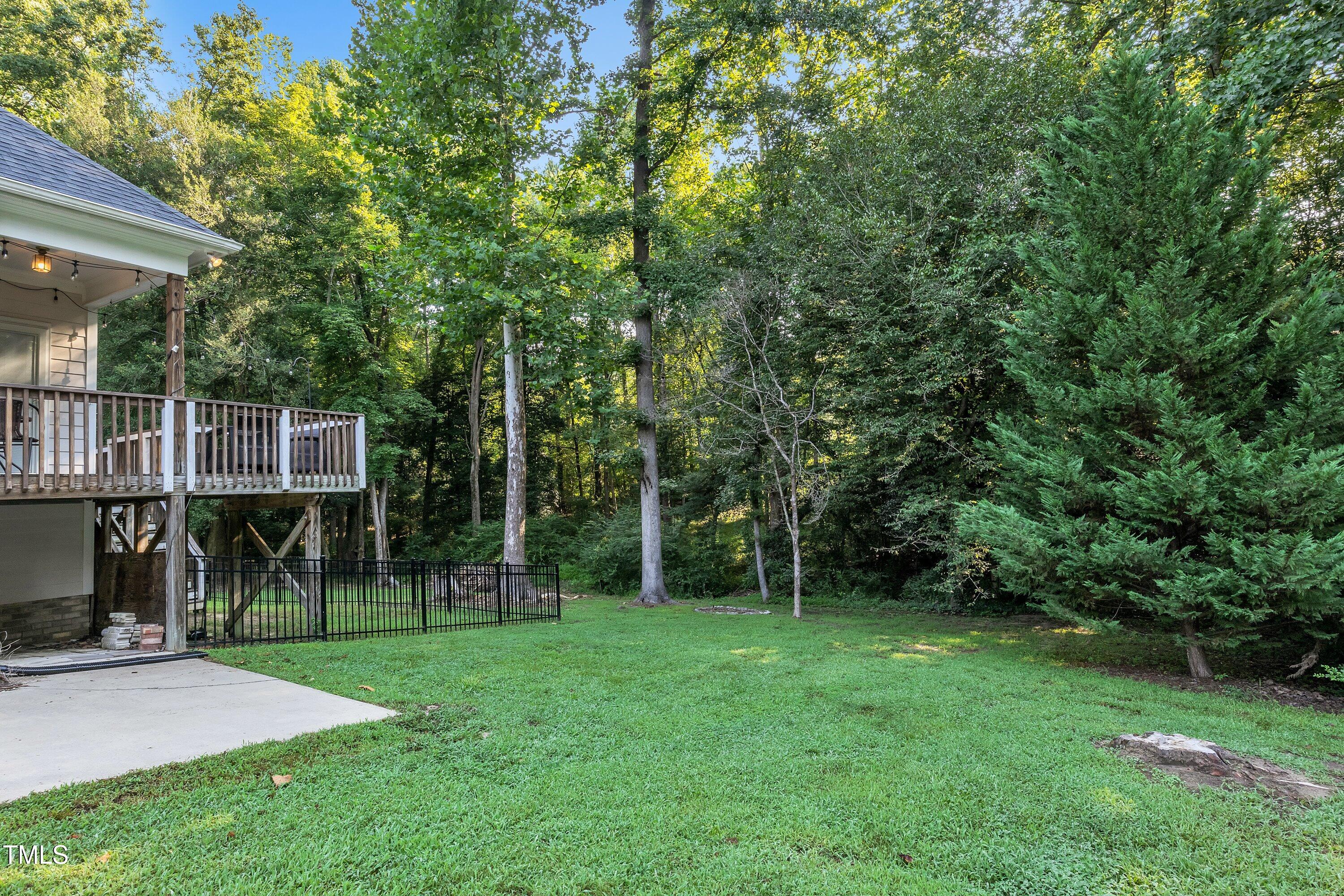 4617 Cherrybark Lane Raleigh, NC 27616 - Photo 46 of 53 a view of a backyard with a garden and trees