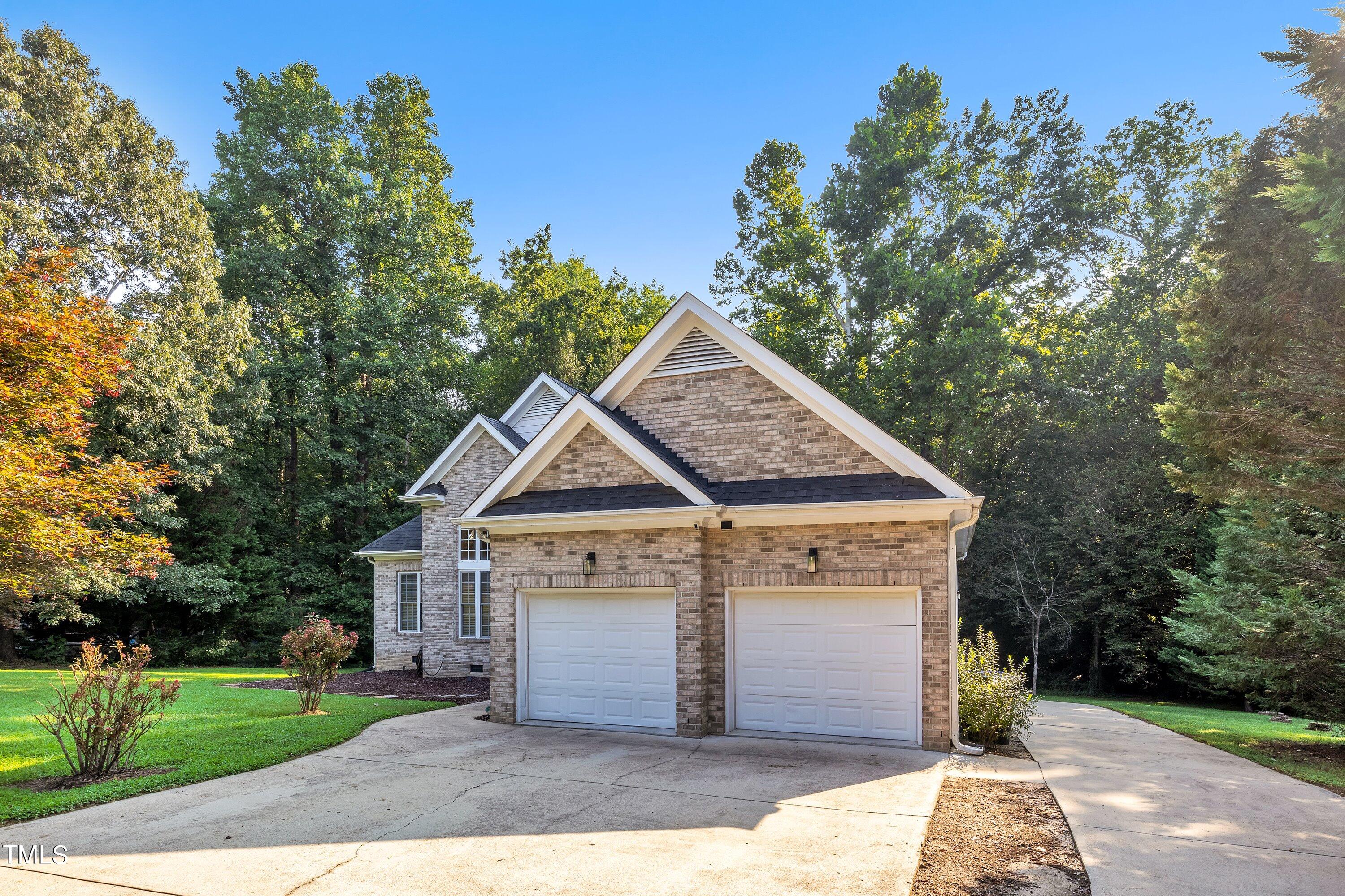 4617 Cherrybark Lane Raleigh, NC 27616 - Photo 6 of 53 a front view of a house with a yard and garage