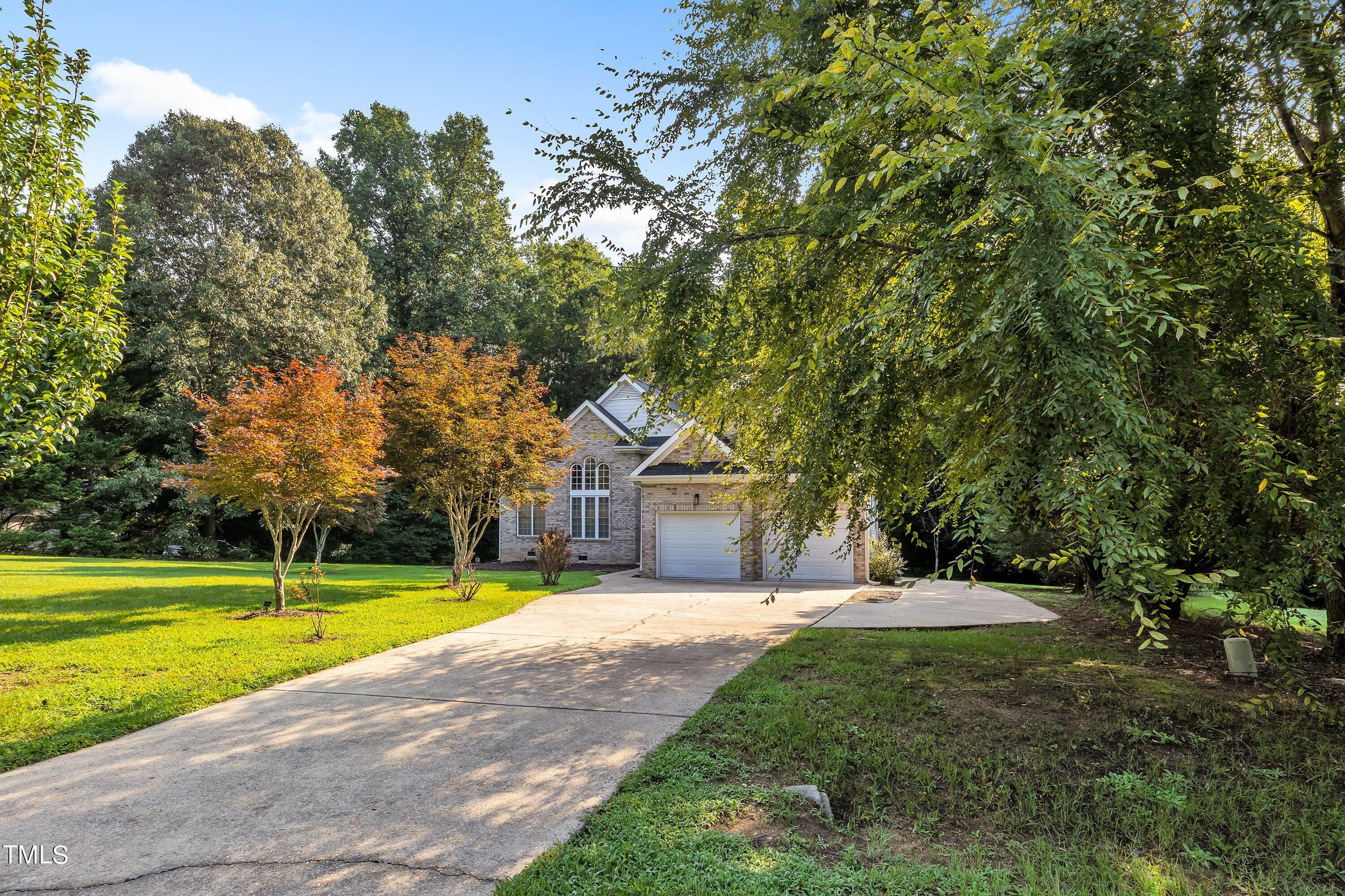4617 Cherrybark Lane Raleigh, NC 27616 - Photo 7 of 53 a view of a house with a big yard and large trees