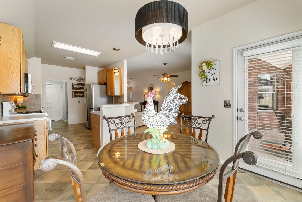 2015 Louetta Brook Court Spring, TX 77388 - Photo 11 of 28 a dining room with furniture a kitchen and chandelier