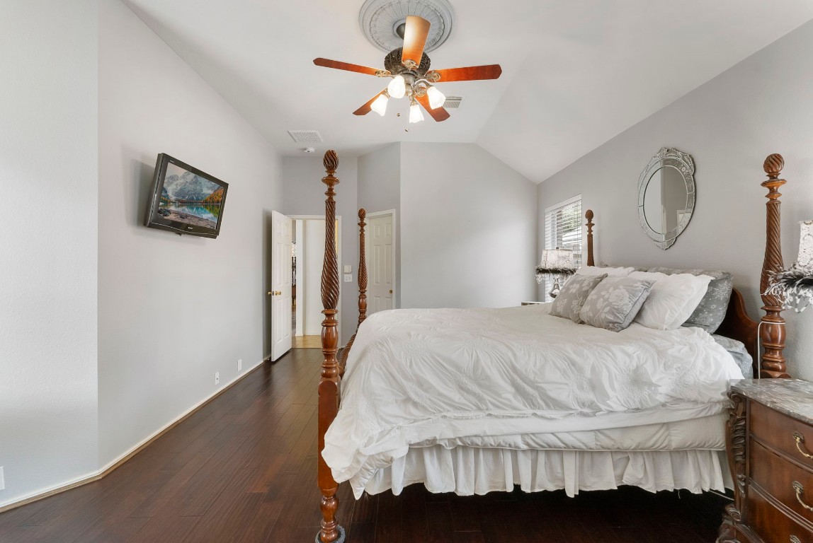 2015 Louetta Brook Court Spring, TX 77388 - Photo 13 of 28 a bedroom with a bed and a chandelier