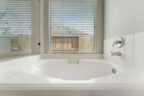 a white bath tub sitting next to a window